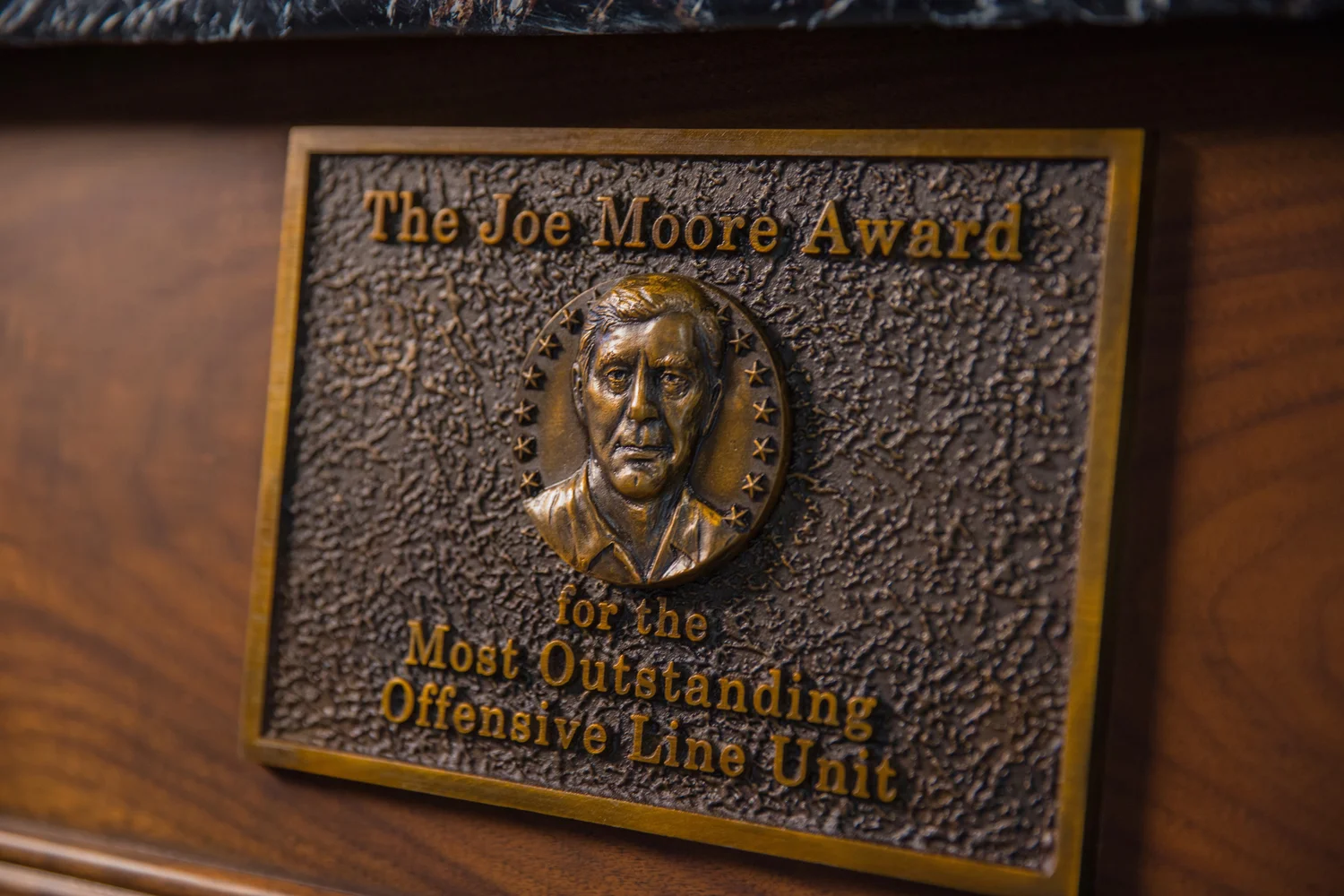 Joe Moore's likeness cast into the base of the trophy